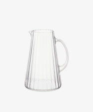The Fresco Pitcher is a clear acrylic glass pitcher with a handle and vertical ribbed design, inspired by Italian café glassware, shown on a plain white background.