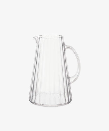The Fresco Pitcher is a clear acrylic glass pitcher with a handle and vertical ribbed design, inspired by Italian café glassware, shown on a plain white background.