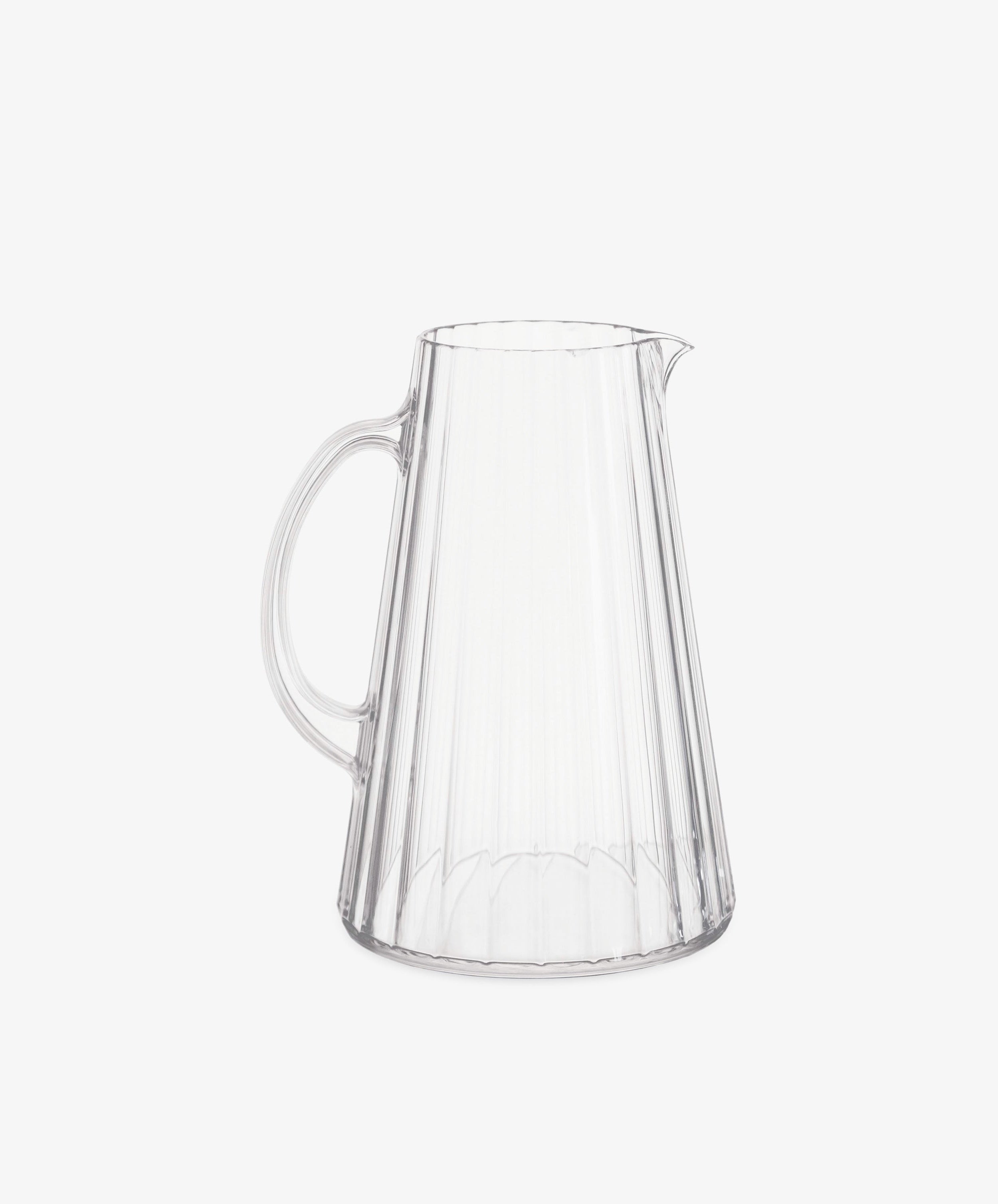 The Fresco Pitcher is a clear, durable pitcher with a handle and spout, featuring vertical ridged lines inspired by Italian café glassware. Shown against a plain white background.