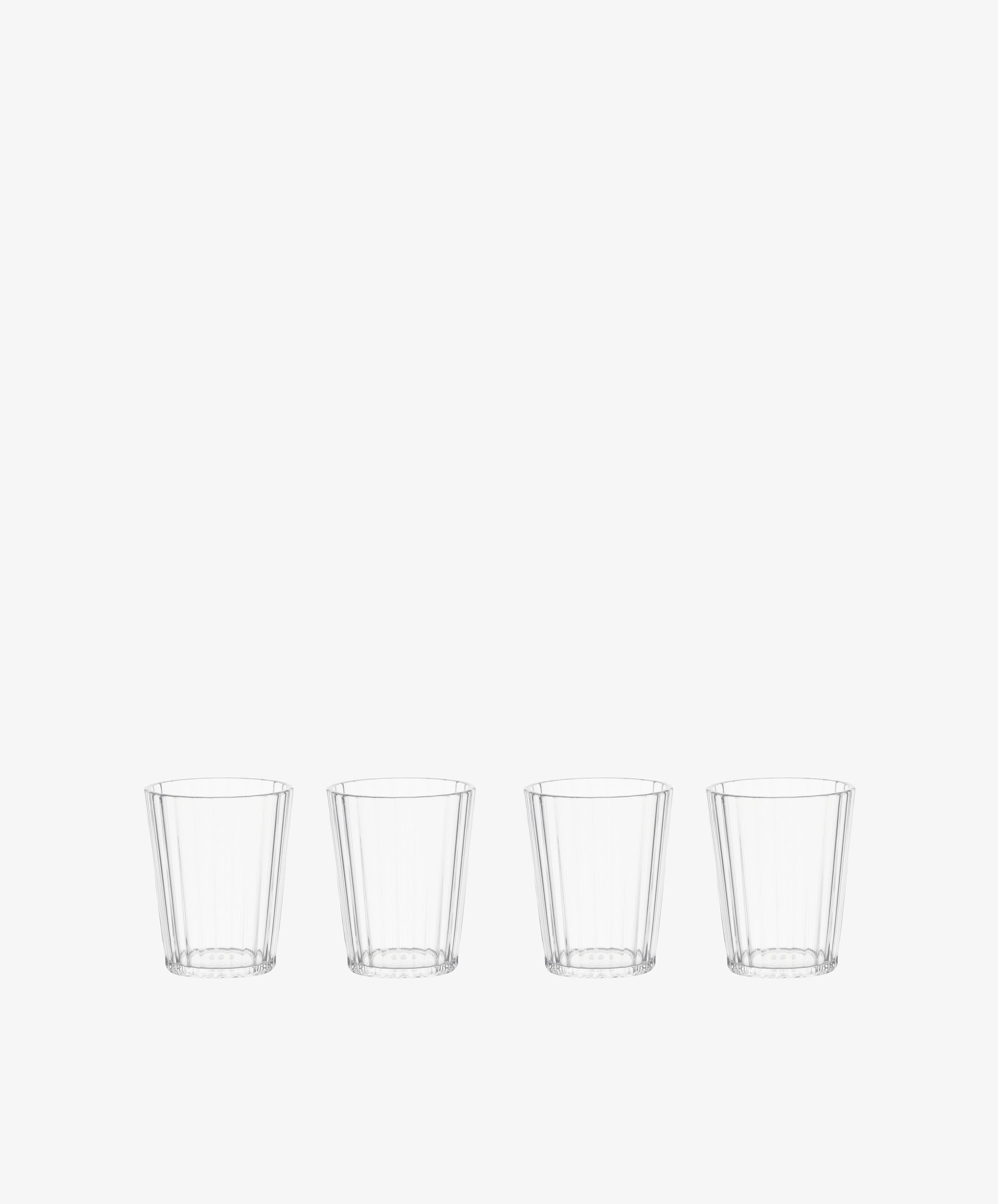 The Fresco Tumbler, Set of 4, features clear, faceted acrylic glasses arranged in a row against a plain white background—stylish and durable drinkware for any occasion.