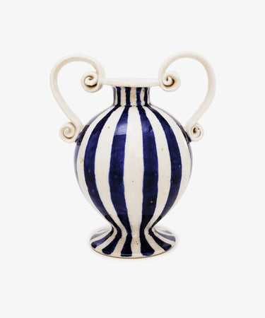 The Cyrene Bud Vase features hand-thrown craftsmanship, blue-and-white vertical stripes, and sculptural scroll handles, shown against a plain white background.