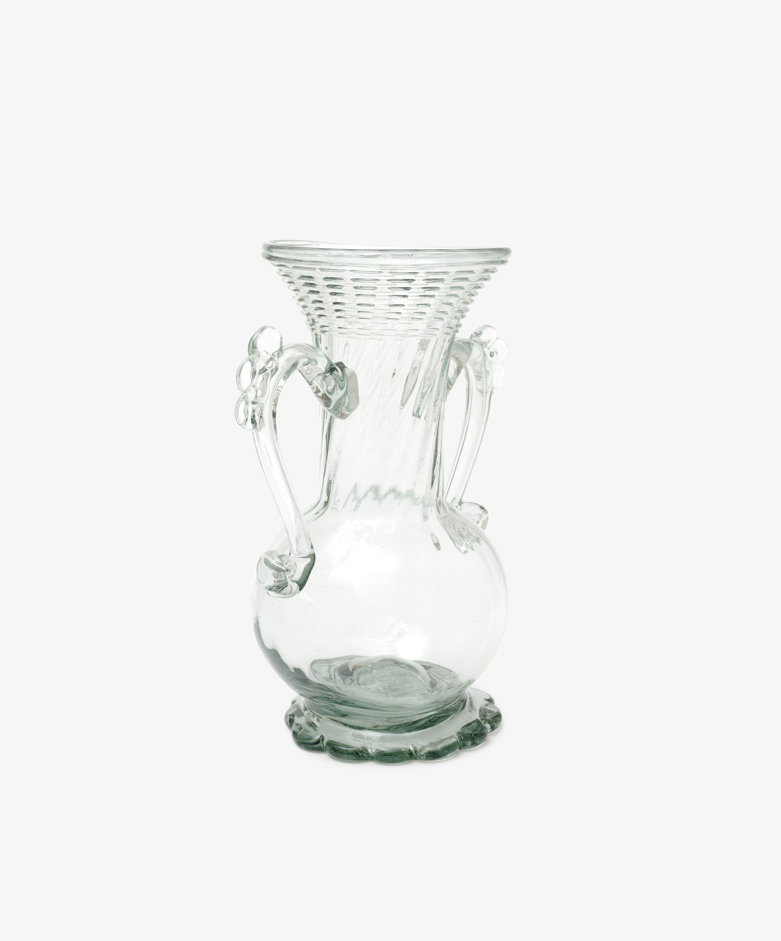 The Camilla Vase is a clear, hand-blown glass vase with a flared textured rim, decorative handles, and a rounded base, highlighting the unique beauty of vases against a plain white background.