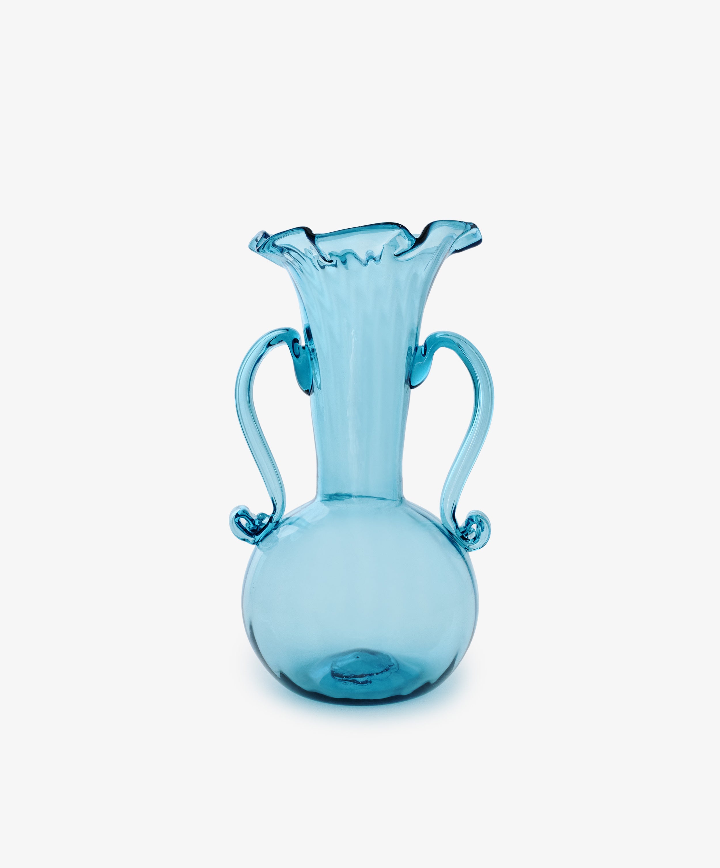 The Camilla Vase is a blue hand-blown glass piece with a round base, two curved handles, and a flared ruffled rim—an eye-catching addition to any collection, shown here against a plain white background.