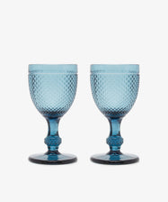 Celeste Red Wine Glass. Two transparent teal blue stemmed wine glasses with diamond cut surface.