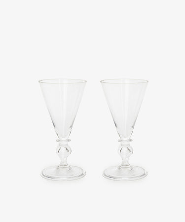 Six Beata Stemmed Wine Glasses are displayed side by side on a plain white background, highlighting the soft elegance of their contemporary design.