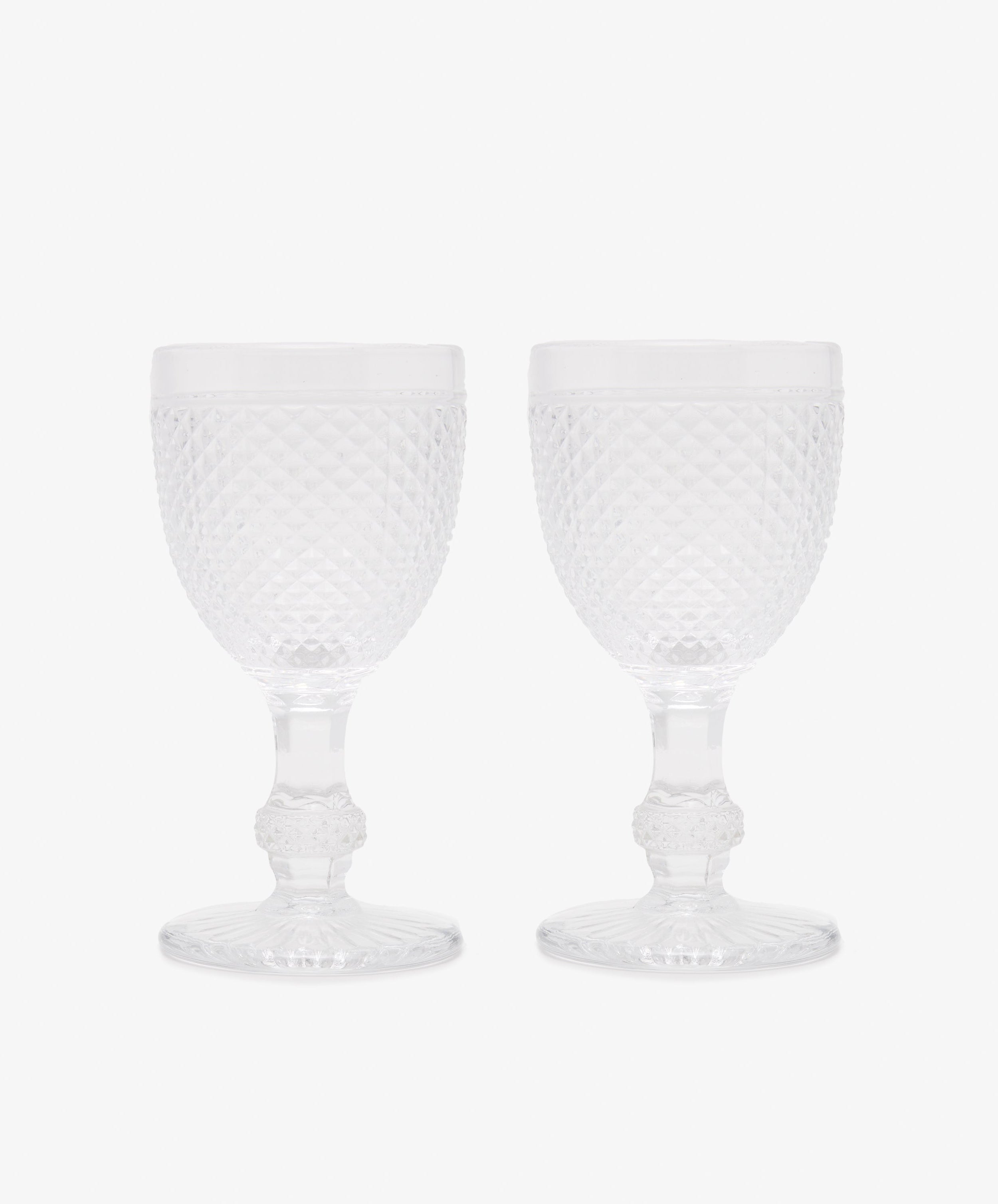 Celeste Red Wine Glass. Two transparent stemmed wine glasses with diamond cut surface.