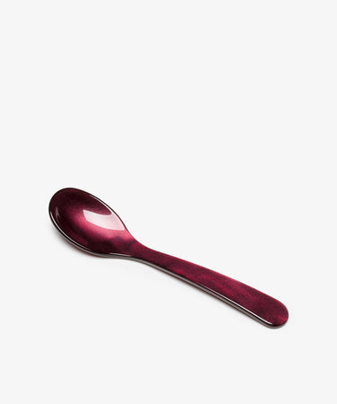 A Piccolo Spoon in maroon acrylic, featuring exquisite design craftsmanship, is displayed against a white background.