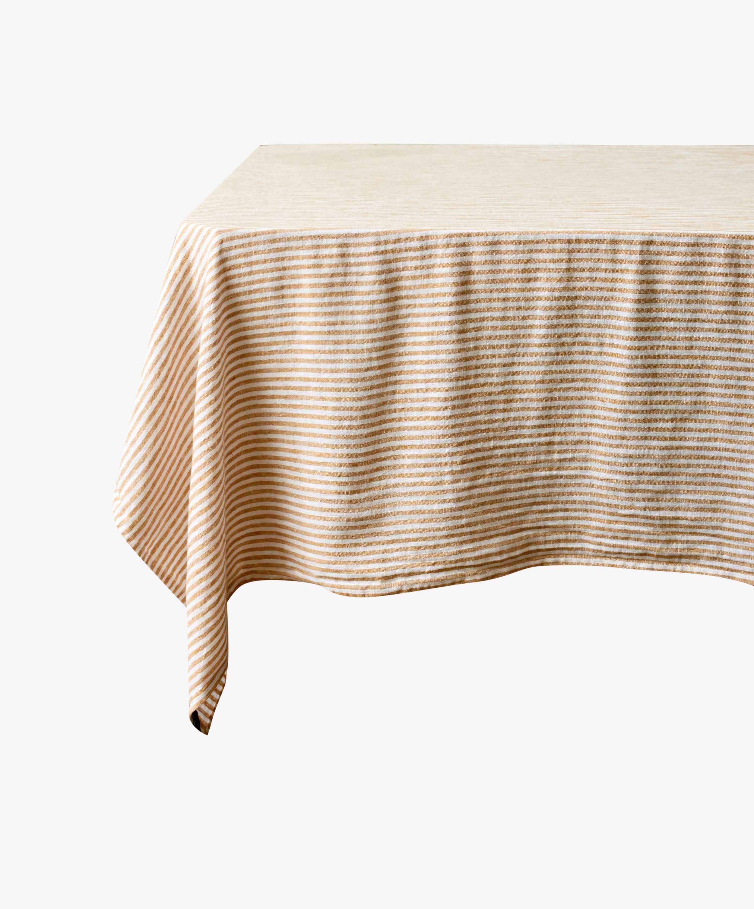 Vezzani Tablecloth in orange and white striped linen, draped on floating table.