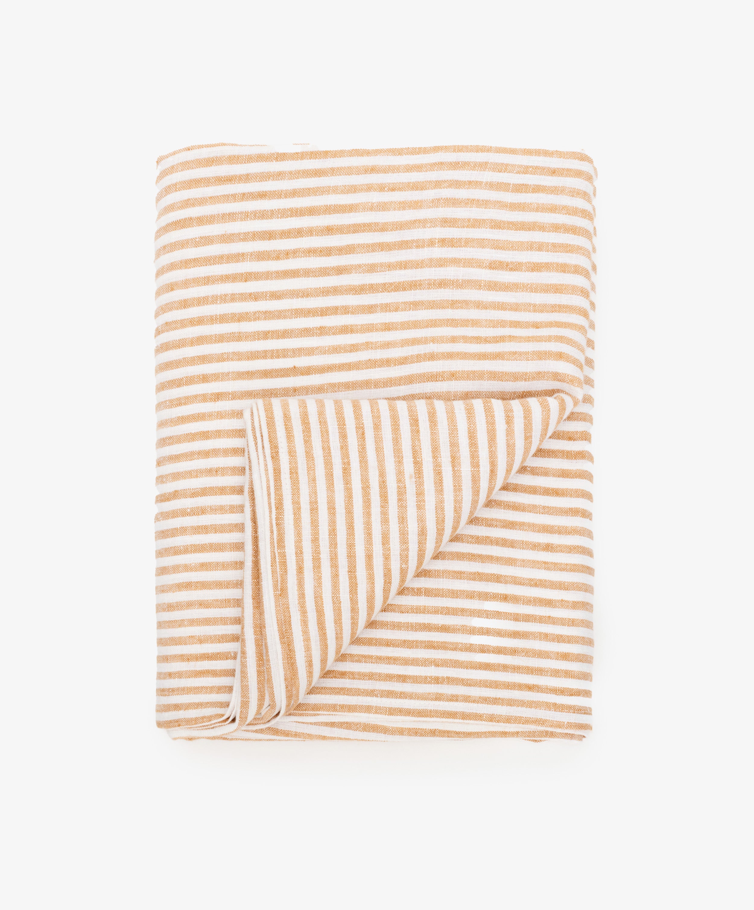 Vezzani Tablecloth in orange and white striped linen, folded with bottom corner flipped up.