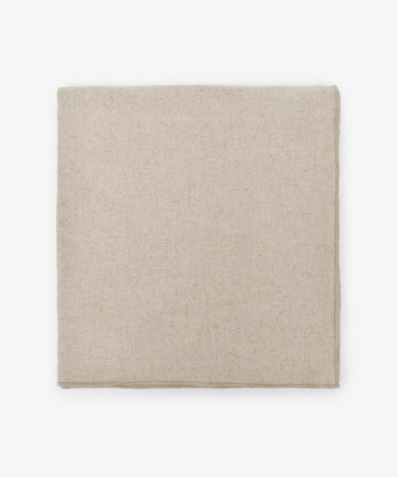 The Corte Tablecloth, in plain beige and neatly folded, rests on a white background—perfect for pairing with matching placemats and napkins.