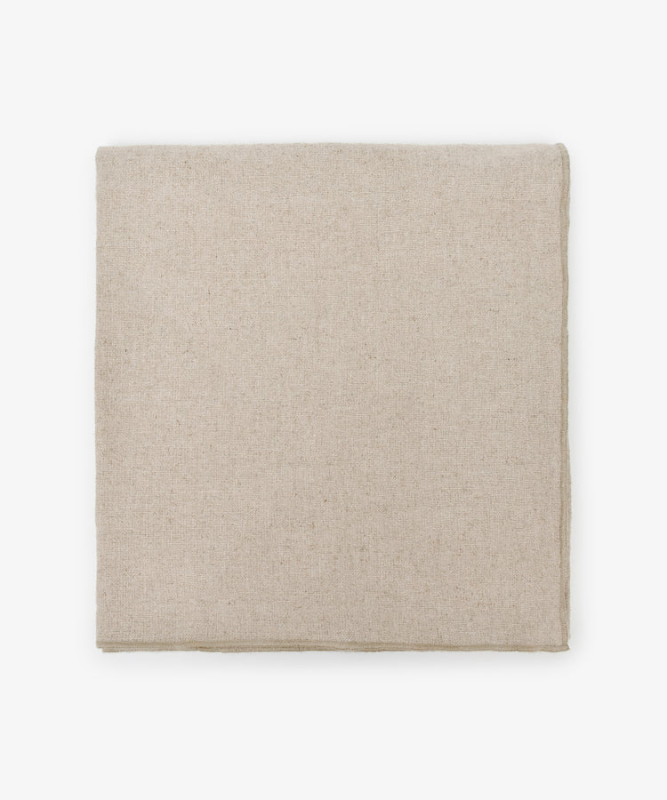 The Corte Tablecloth, in plain beige and neatly folded, rests on a white background—perfect for pairing with matching placemats and napkins.