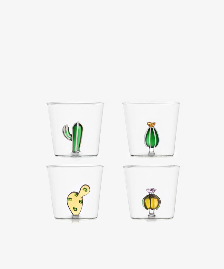 The Agave Tumbler Set of 4 features clear borosilicate glasses, each with a distinct colorful cactus or plant design at the base, arranged in a two-by-two grid on white—unique pieces to add charm to any table setting.