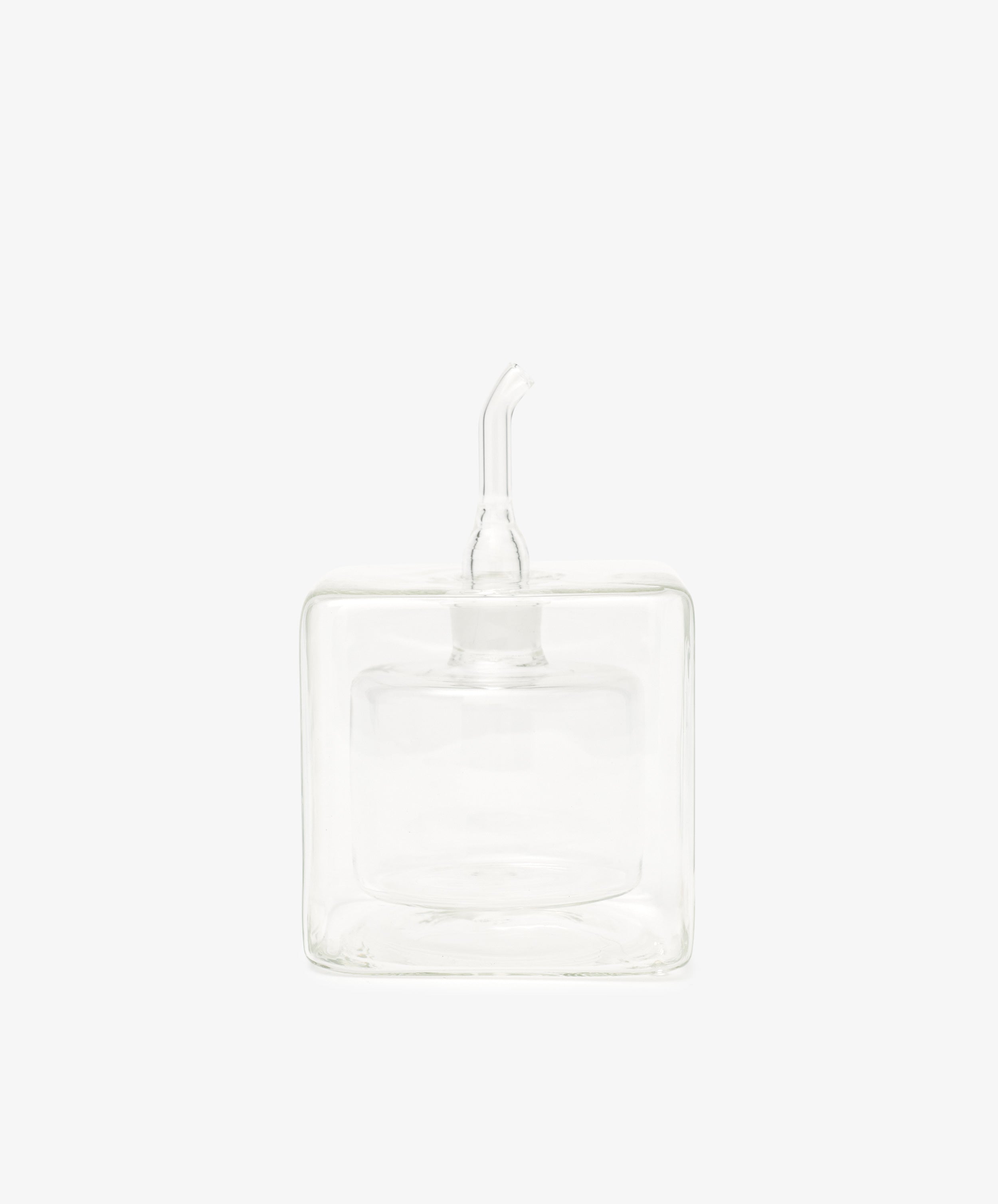 The Cube Oil & Vinegar Cruet features a clear glass, square body and short spout—ideal for any kitchen. Photographed on a plain white background.