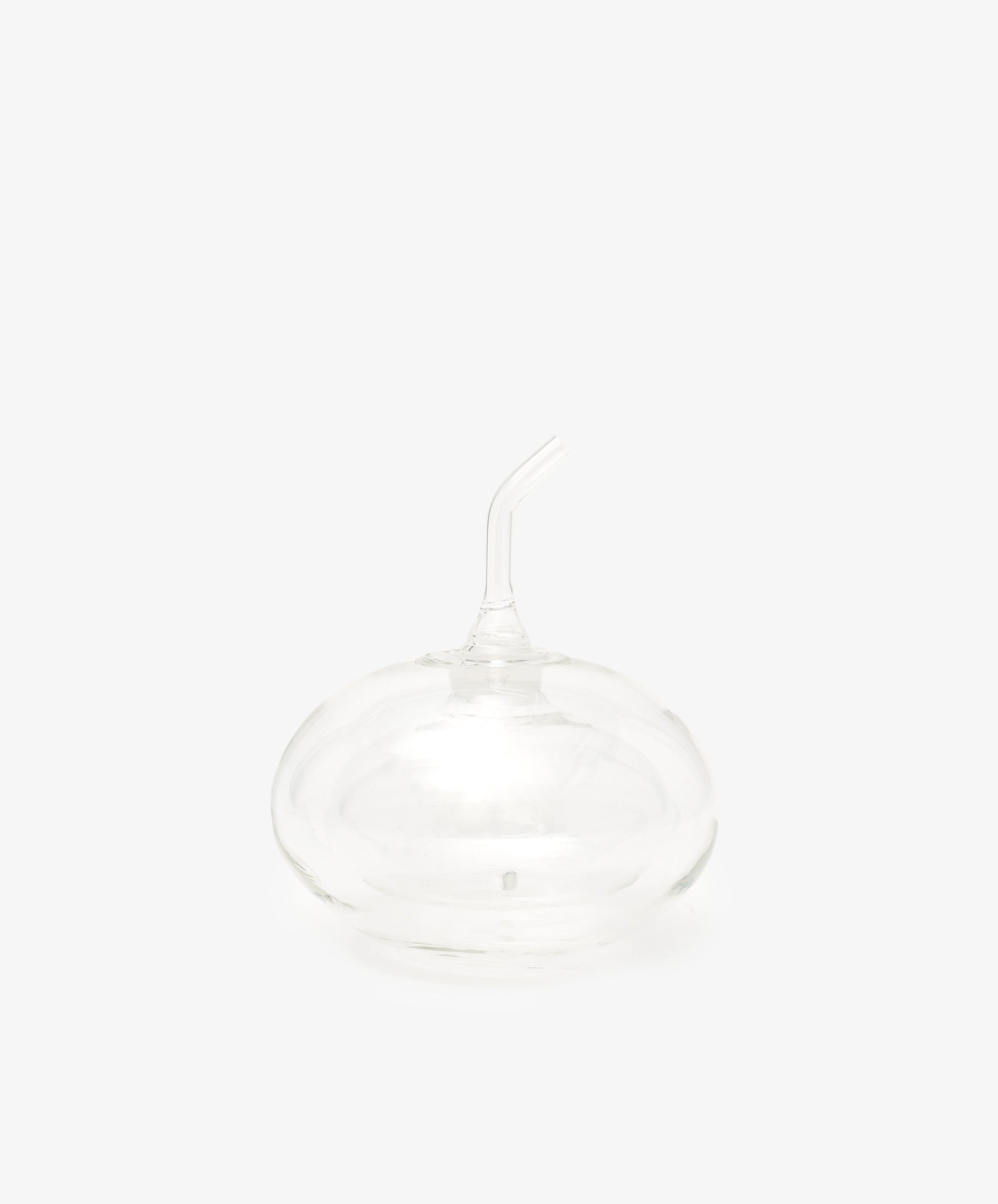The Cylinder Oil & Vinegar Cruet features clear glass with a rounded base and curved spout, reminiscent of elegant cruets, displayed against a plain white background.