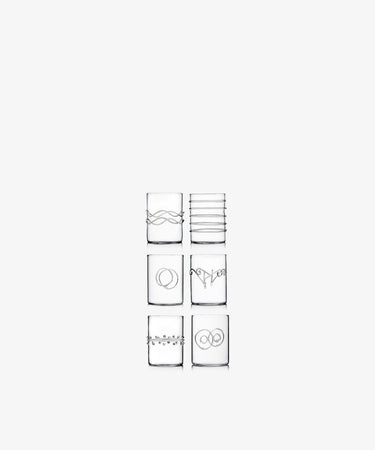 The Deco Shot Glass, Set of 6, features unique etched line designs and is shown in two columns on a white background—ideal for serving limoncello or grappa.