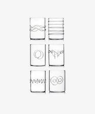 The Deco Shot Glass Set of 6 features clear glasses, each adorned with a unique minimalist silver wire design—arranged in two rows of three—ideal for serving grappa or limoncello with elegance.