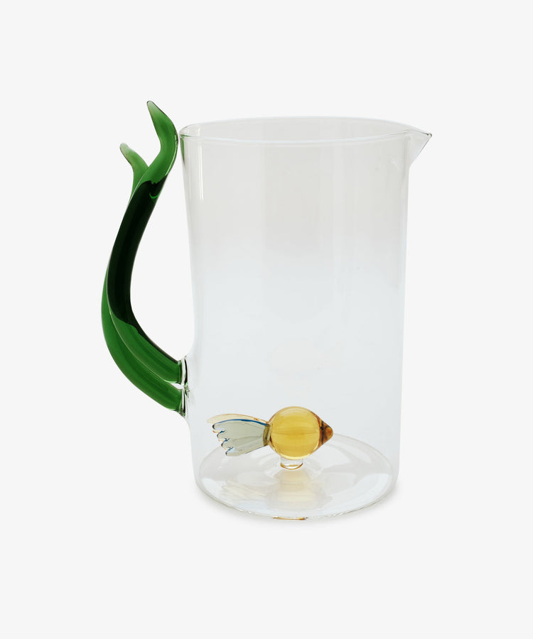 The Fish Pitcher features clear borosilicate glass, a tail-shaped green handle, and a hand-blown fish at the bottom, bringing aquatic beauty to your table.