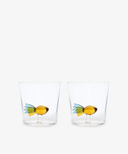 The Fish Tumbler, Set of 2 includes two clear handcrafted glass tumblers, each featuring a small, colorful fish design at the bottom.