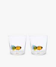 The Fish Tumbler, Set of 2, features handcrafted clear glass tumblers with decorative yellow and green fish figurines inside, showcasing Ichendorf Milano’s unique design against a plain white background.