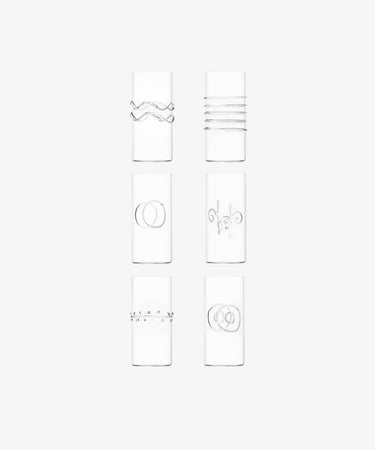 The Deco Tall Water Glass Set includes six clear glasses, each with a unique minimalist etched design—an elegant way to enhance your colorful glassware collection.