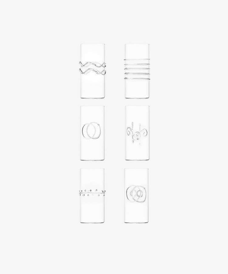 The Deco Tall Water Glass Set includes six clear glasses, each with a unique minimalist etched design—an elegant way to enhance your colorful glassware collection.