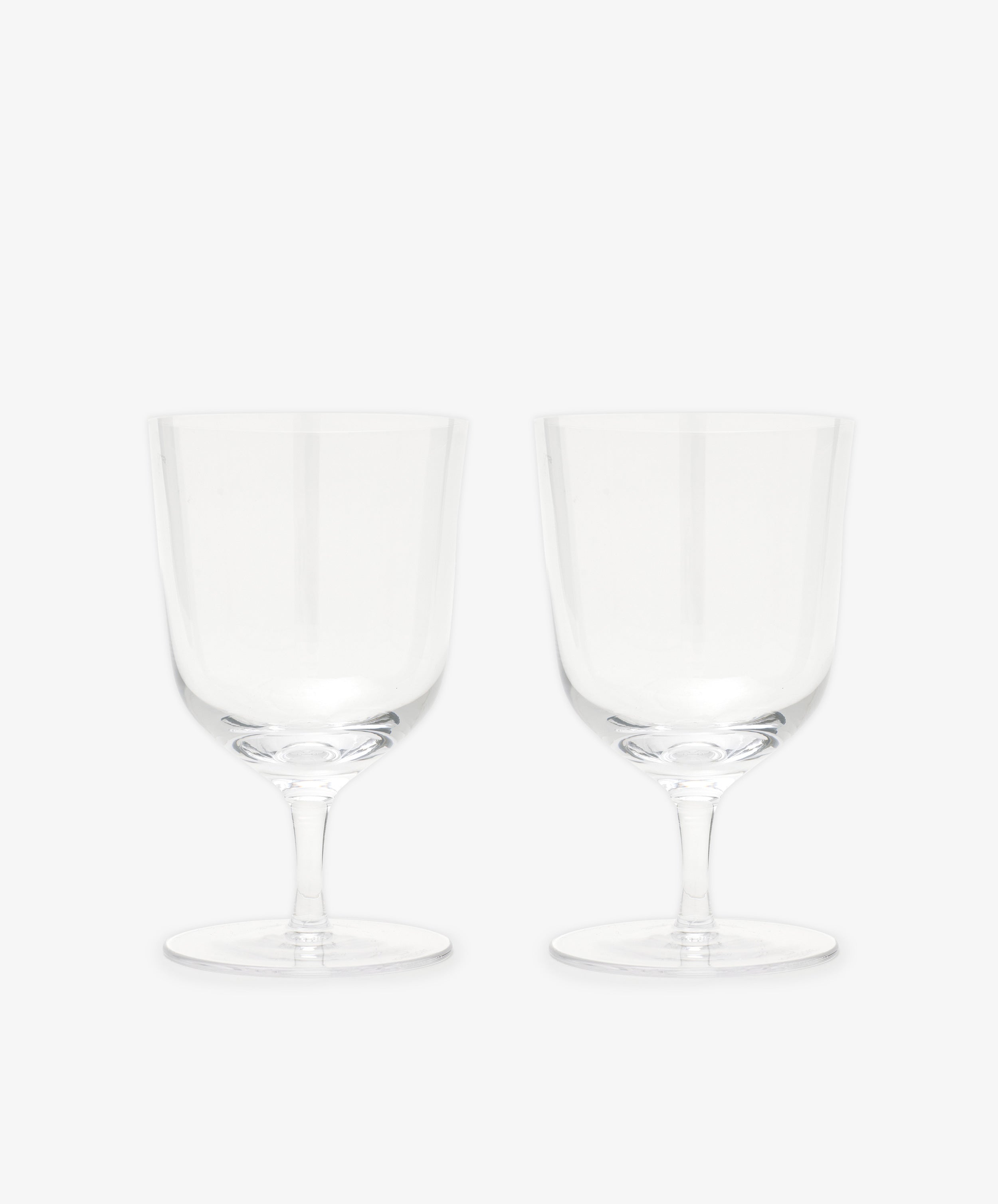 The Venezia Water Glass set of 6 features elegant, handblown clear glasses with short stems, displayed side by side on a plain white background—perfect glassware for any setting.
