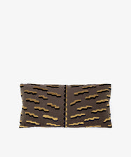 The Polo Lumbar Cushion is a rectangular pillow with a brown cover and abstract zigzag pattern in beige, black, and navy, made from deadstock designer fabric for premium quality and limited availability. Shown on a plain white background.