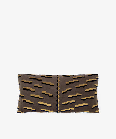 The Polo Lumbar Cushion is a rectangular pillow with a brown cover and abstract zigzag pattern in beige, black, and navy, made from deadstock designer fabric for premium quality and limited availability. Shown on a plain white background.