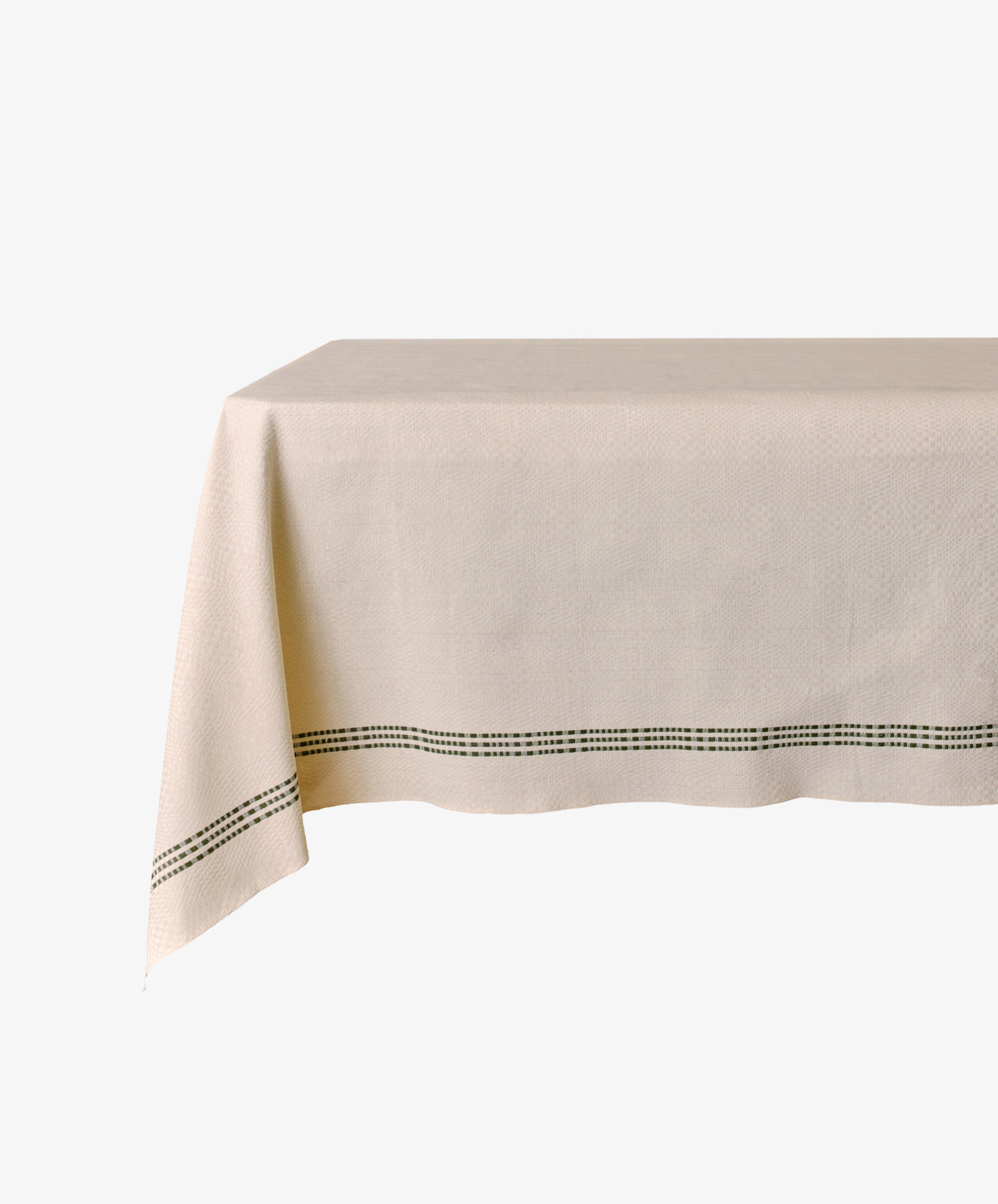 The Tilde Tablecloth is a rectangular Swedish design made from light beige cotton-linen, featuring a subtle texture and a simple black dotted border near the edge.