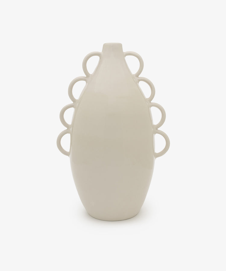The Brisa Vase is a white ceramic piece with a minimal form and smooth surface, featuring six sculptural loops—three per side—for added charm, shown against a plain white background.