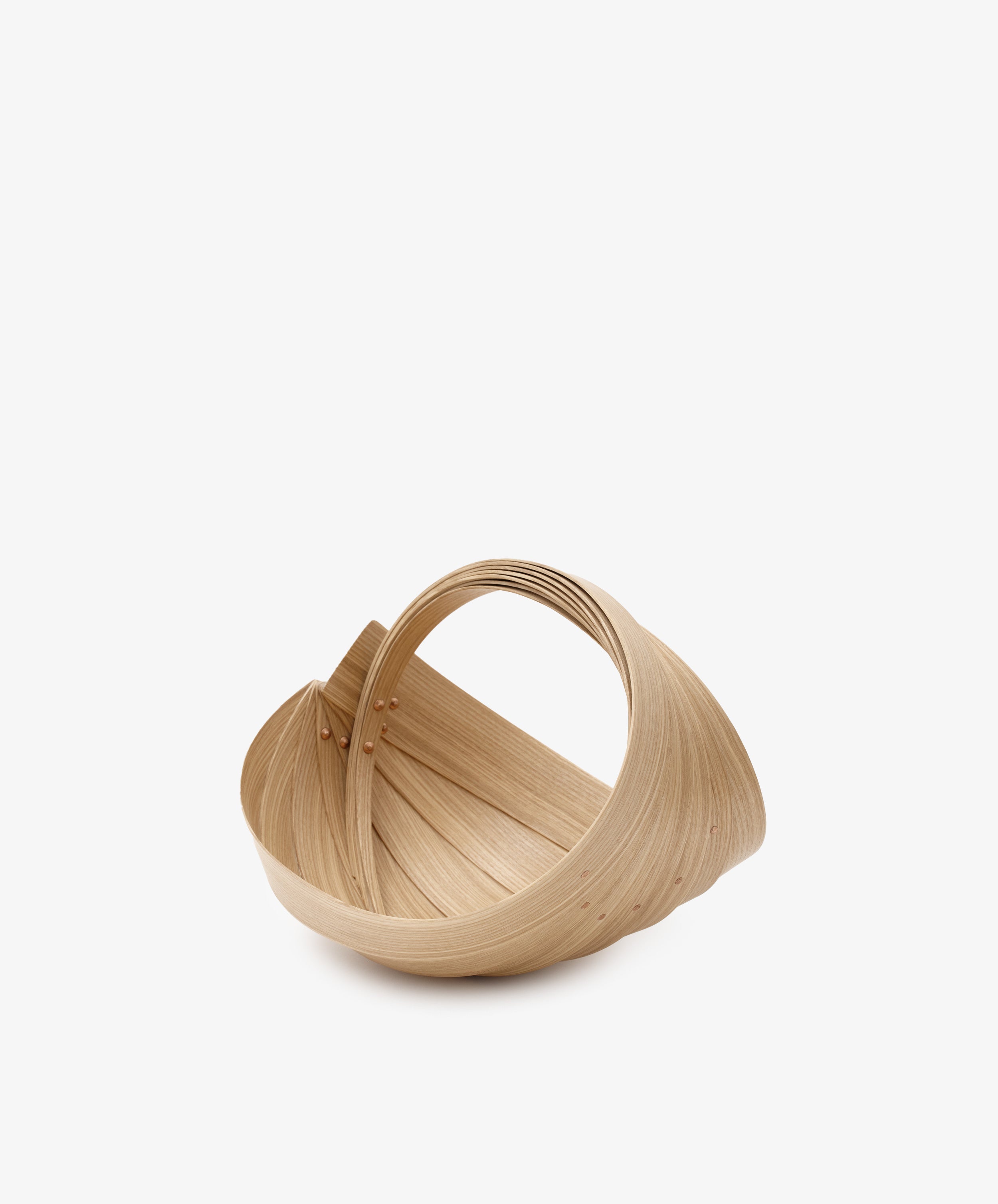 The Fern Trug by Jane Crisp. Bent light olive wood minimalist basket with rounded handle, alt view.