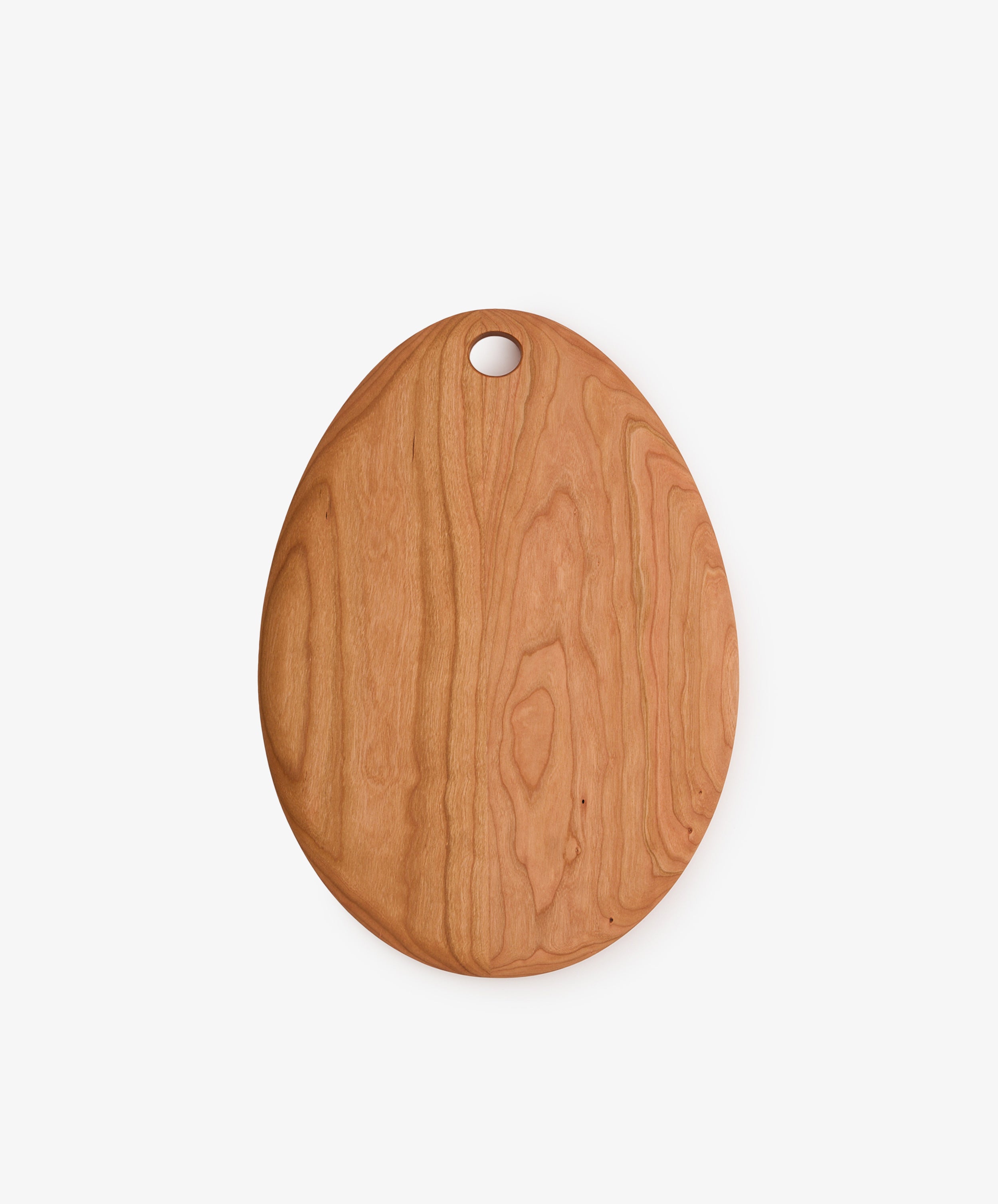 Alden Egg Board—an oval cherry wood cutting board featuring a hole near the top, displayed on a plain white background; perfect as a small cheese board or an elegant wooden serving board.