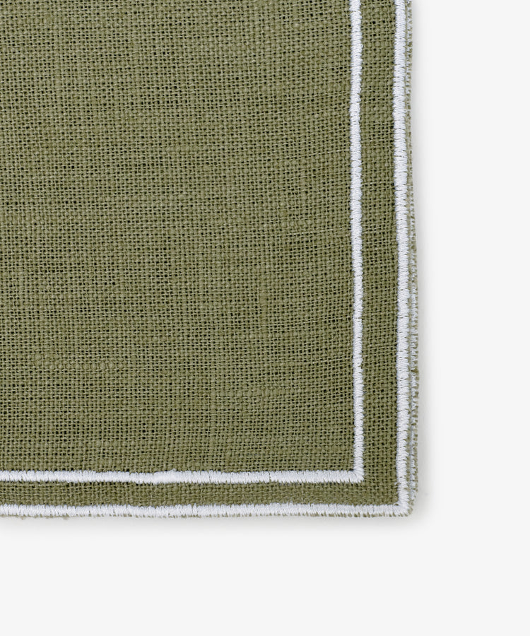 Close-up of a textured olive green Flavia Napkin (Set of 6) with white double-line stitched borders, shown on a white background.