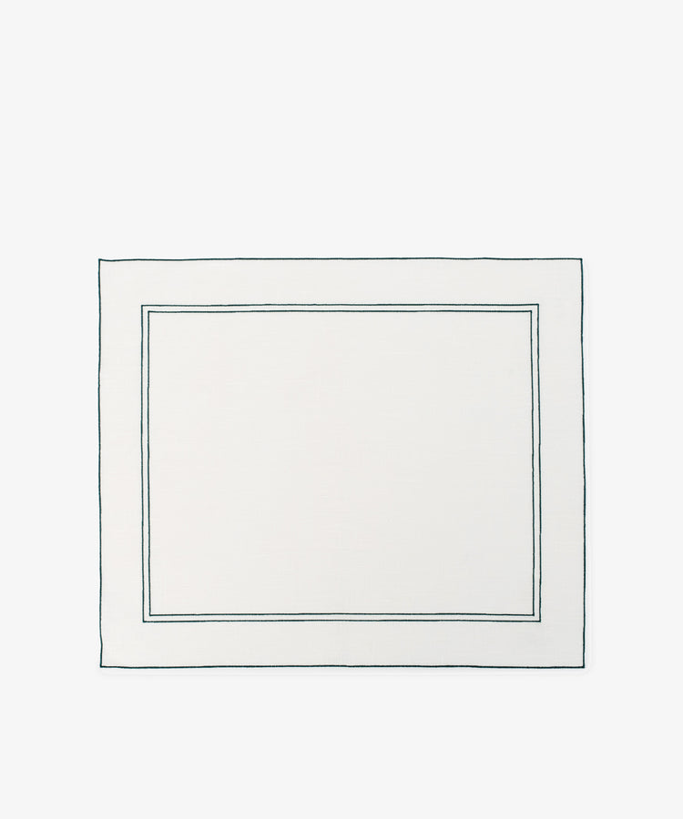 The Flavia Placemat, Set of 6, features rectangular white linen with two thin dark-bordered outlines near the edges—a refined and durable choice for elegant table settings.