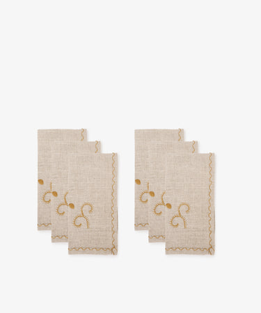Two sets of Inez Napkin, Set of 6, crafted from beige linen with traditional gold and burgundy embroidered designs and scalloped edges, displayed on a white background.