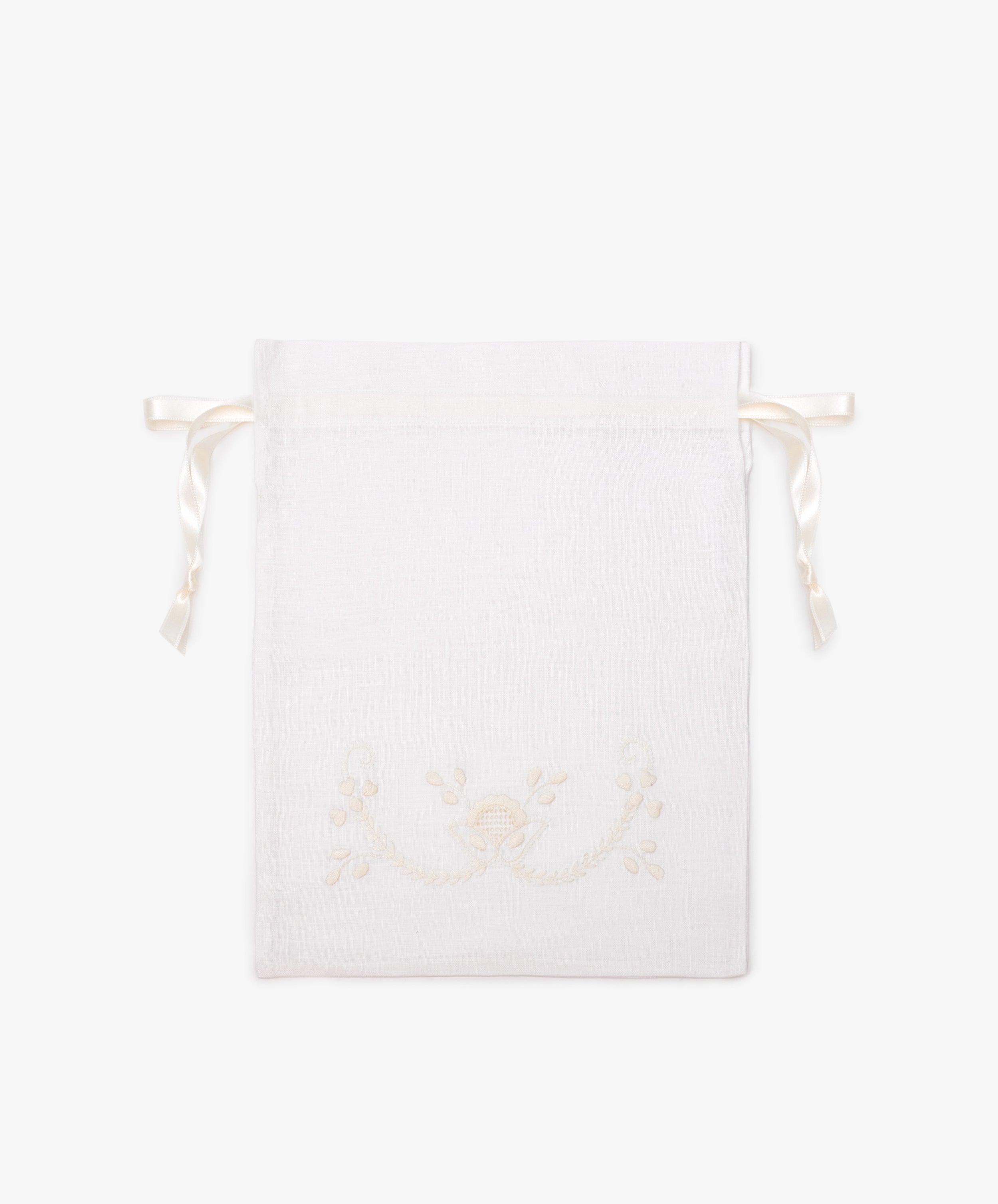 The Linen Drawstring Bag is handmade in Portugal from white linen, with cream Viana do Castelo embroidery and ribbon ties. Shown flat on a plain light background.
