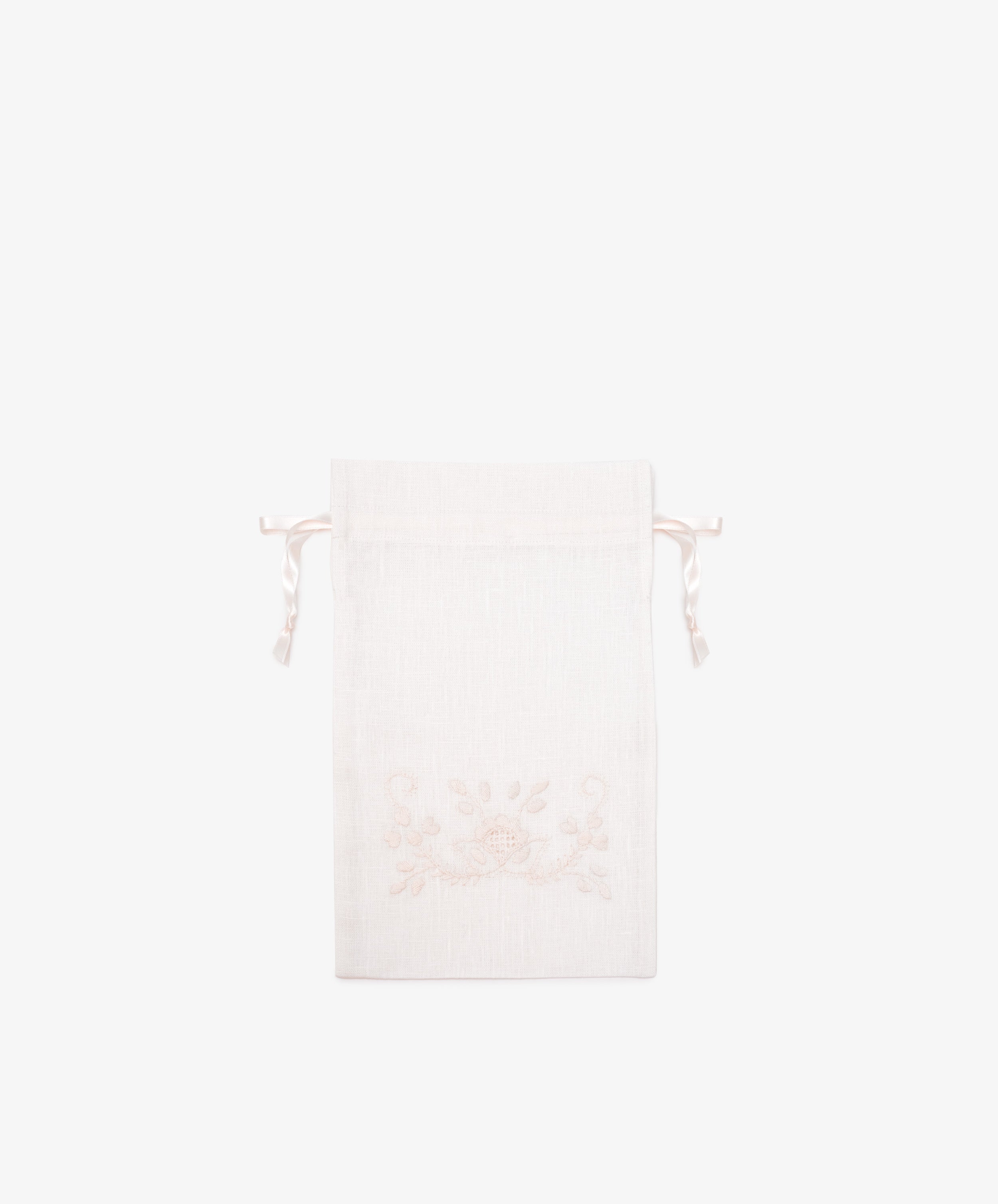 The Linen Drawstring Bag, handmade in Portugal from light-colored linen, features subtle Viana do Castelo embroidery on the front and is shown against a plain white background.