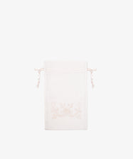 The Linen Drawstring Bag, handmade in Portugal from light-colored linen, features subtle Viana do Castelo embroidery on the front and is shown against a plain white background.