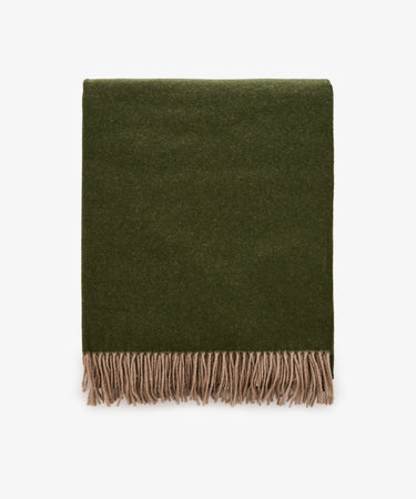 A folded Ulisse Throw in forest green with beige fringe along the bottom edge, displayed on a white background.