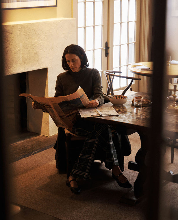 woman reading the paper