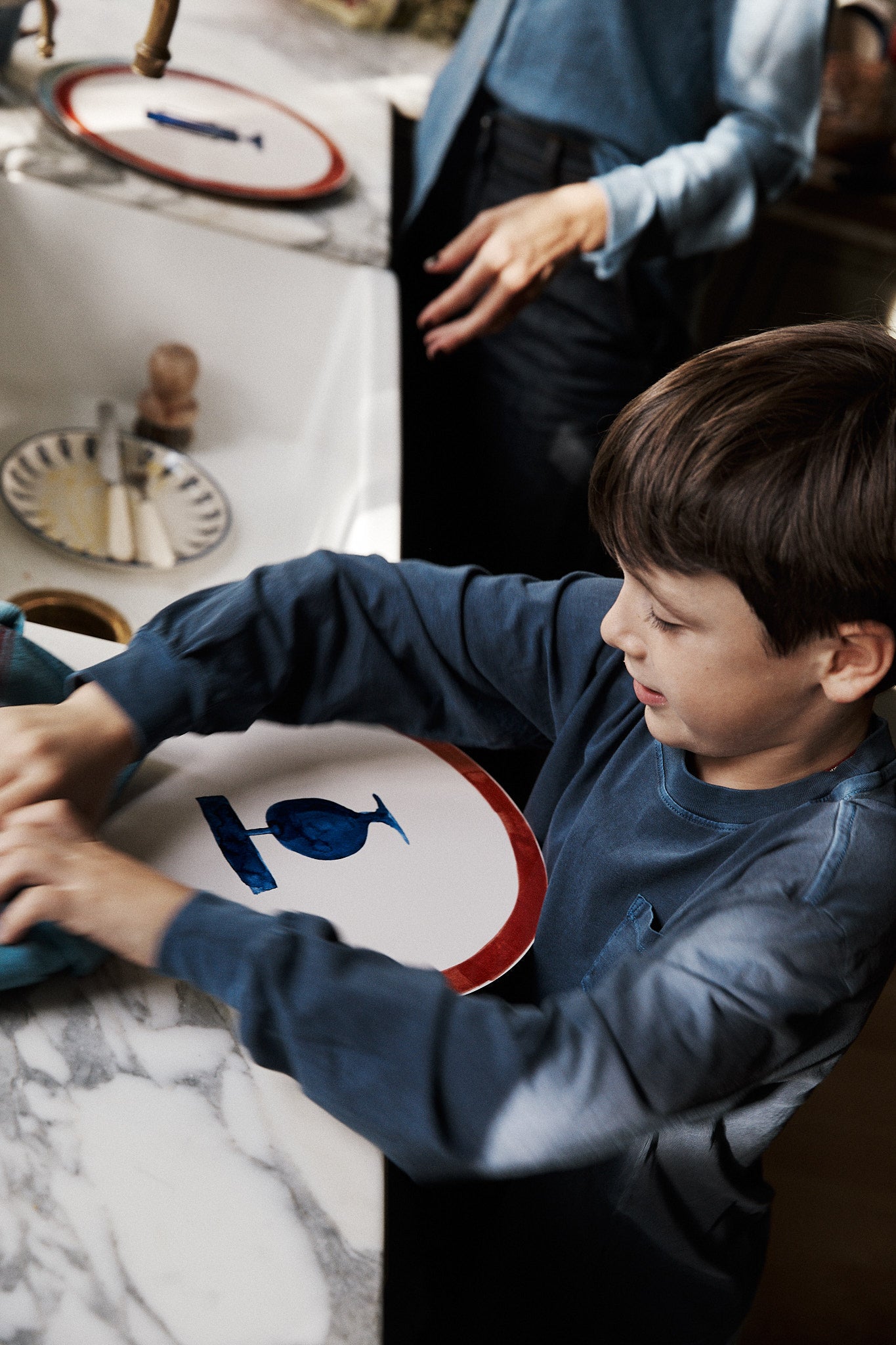 Child in a kitchen setting with a marble countertop
