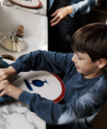 Child in a kitchen setting with a marble countertop