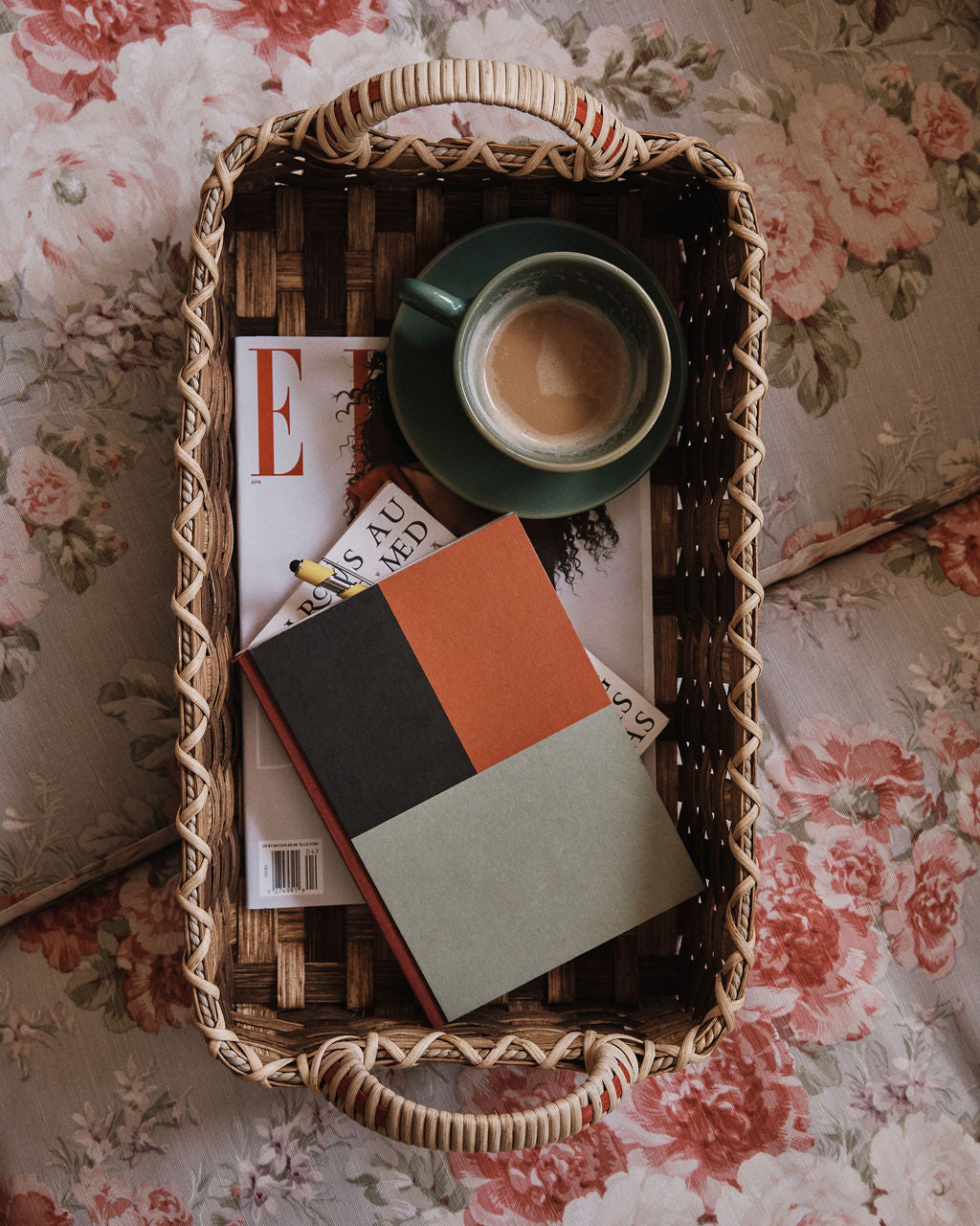 The Folk Fleur Breakfast Tray displays a coffee cup, a closed notebook, and a magazine on a floral-patterned surface.