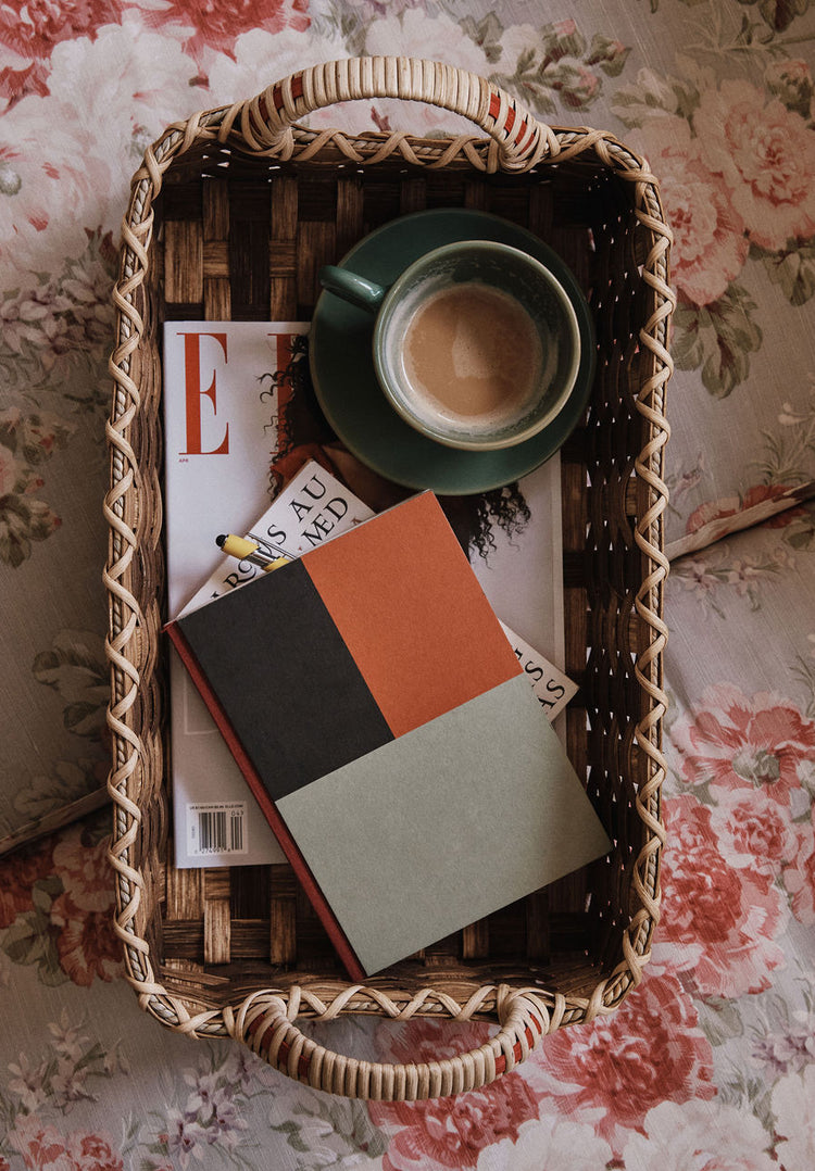 The Folk Fleur Breakfast Tray displays a coffee cup, a closed notebook, and a magazine on a floral-patterned surface.