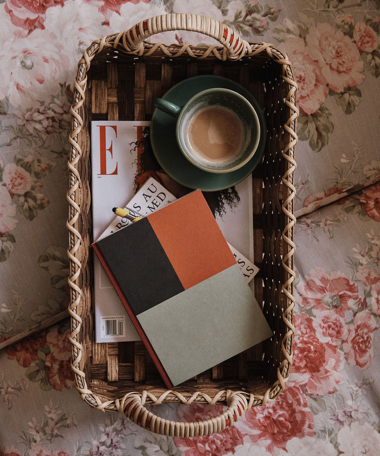 The Folk Fleur Breakfast Tray displays a coffee cup, a closed notebook, and a magazine on a floral-patterned surface.