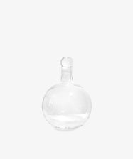The Bubble Glass Carafe features a clear, round design with a narrow neck and matching glass stopper, displayed against a plain white background.