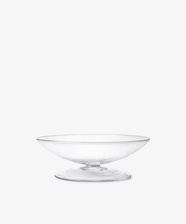 The Bubble Glass Grape Tray features a clear, wide, shallow pedestal design that highlights exquisite glass-blowing artistry, resembling a sculptural tray, and is shown against a plain white background.