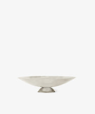 The Metal Grape Tray is a minimalist, shallow polished steel tray featuring a wide rim and small circular base, shown on a plain white background.