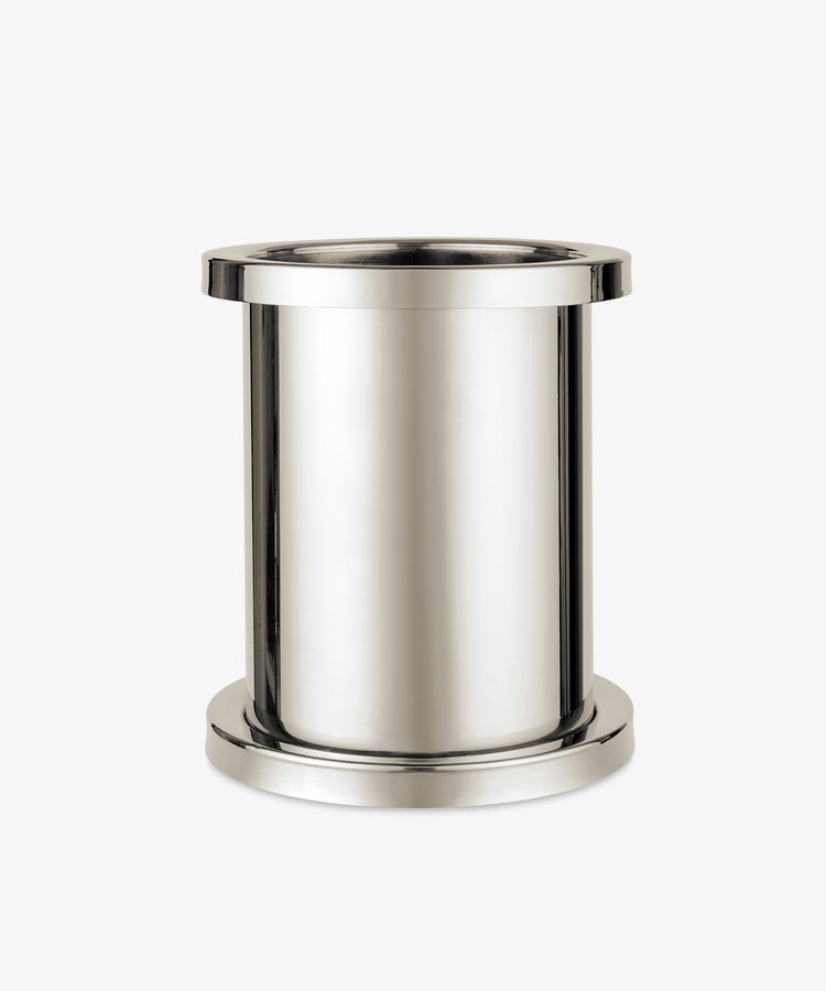 The Metal Wine Cooler features a polished steel finish, cylindrical shape, wide rim, and sturdy base, displayed against a plain white background.