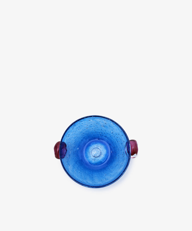 Pavot Snack Bowl. Blue bubble glass bowl with magenta knob handles, overhead view.